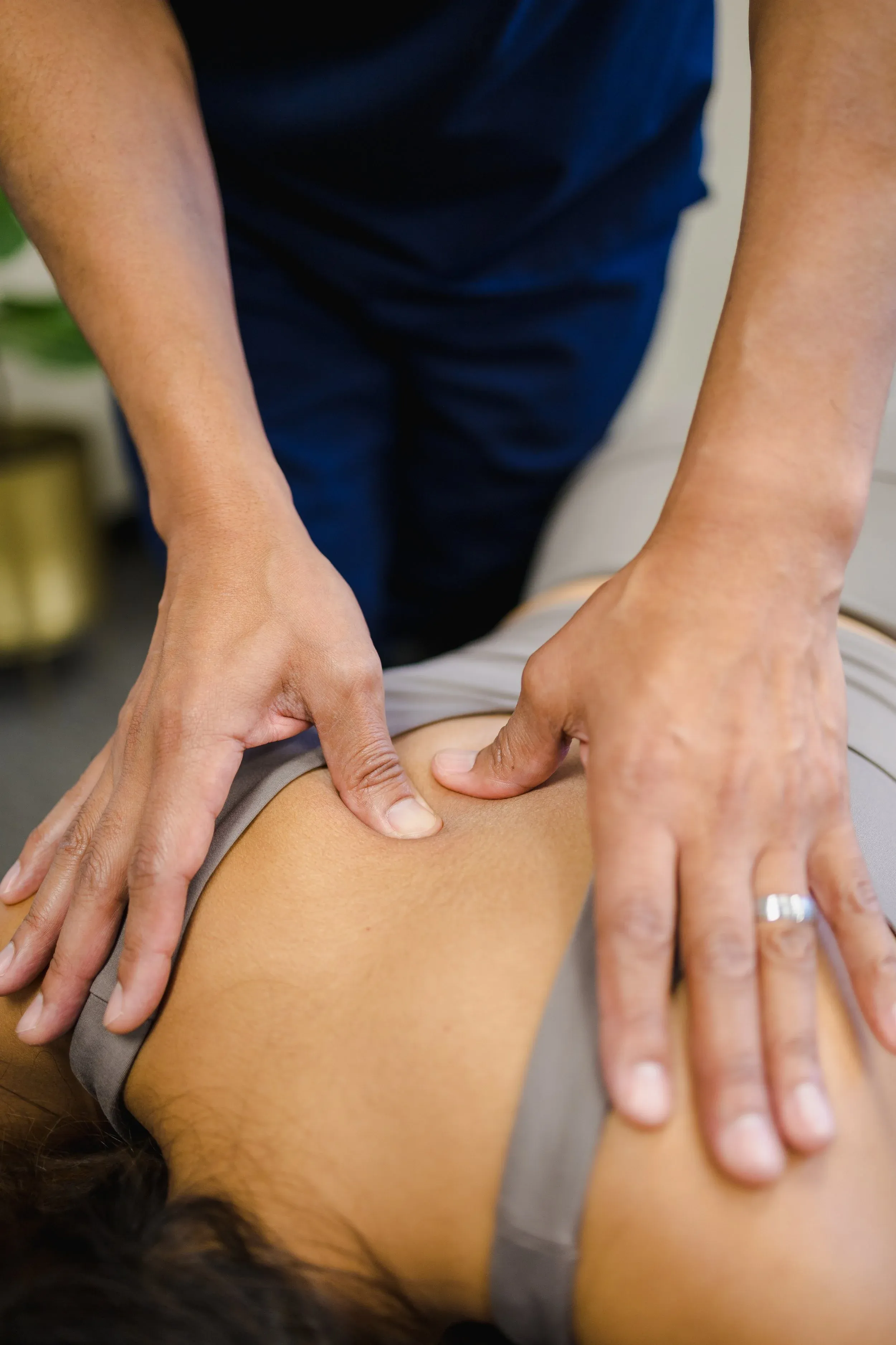 Chiropractor performing hands-on treatment on a patient's shoulders