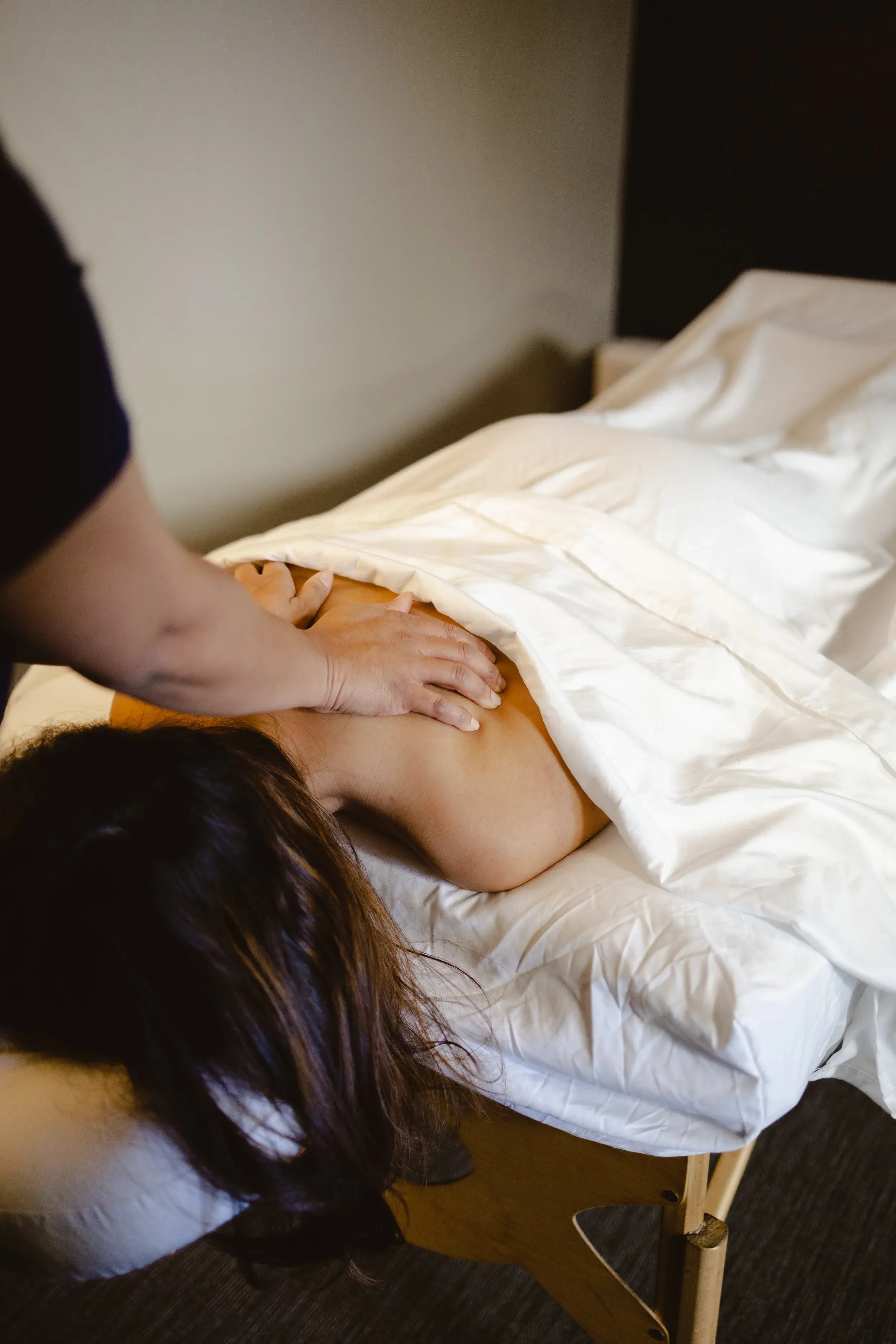 Massage therapy session in a warm, quiet treatment room